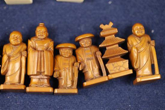 An unusual late 19th century Japanese brown stained and natural ivory figural chess set, kings 1.75in.